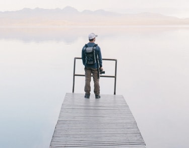man looking at lake